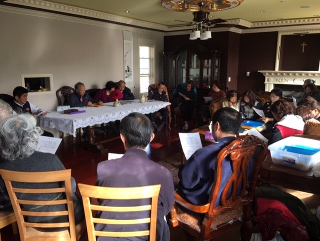 Church members gathering in a home for Bible study and discipleship