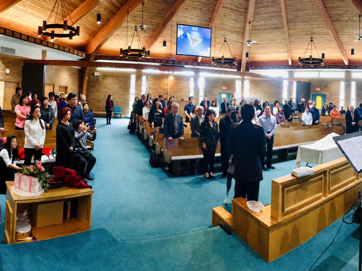A multigenerational congregation worshipping during a Sunday service at Salvation Army New Life Church